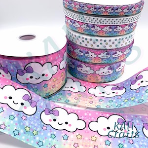 May include: A stack of colorful ribbon featuring a rainbow gradient with white clouds and stars. The clouds have a cute cartoon face with a pink bow. The ribbon is perfect for crafting and decorating.