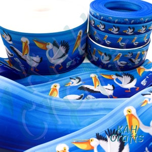 Nastro grosgrain sfumato blu con pellicani e pesci USDR. Scegli la larghezza.