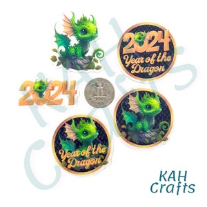 May include: A collection of stickers featuring a green dragon with large eyes. Some stickers have the text "2024 Year of the Dragon" in gold. A quarter is included for size reference. The stickers are from KAH Crafts.