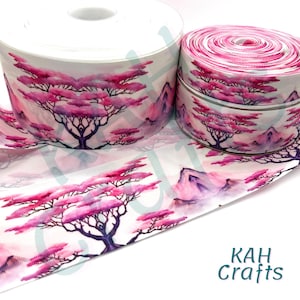 Puede incluir: Rollos de cinta blanca con un patrón repetido de árboles rosas y montañas moradas. El diseño de la cinta presenta un estilo acuarela con el texto "KAH Crafts" en turquesa.