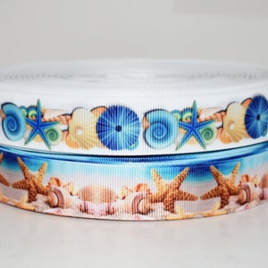 May include: Two rolls of white satin ribbon with a blue and white seashell and starfish print. The ribbon is perfect for crafting and decorating.