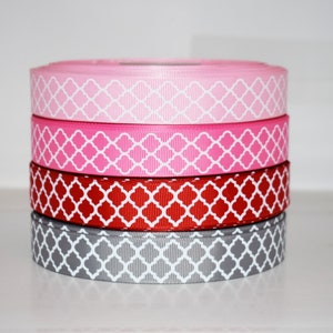 May include: Four rolls of patterned ribbon in pink, red, gray, and white. The ribbon has a geometric design.
