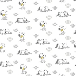 May include: White background with a repeating pattern of Snoopy in various poses, including sitting and sleeping. The design also features gray paw prints scattered throughout. The cartoon dog is depicted in black and white with a yellow accent.