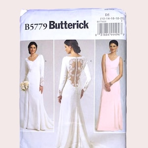 May include: A Butterick B5779 sewing pattern envelope for sizes 12-14-16-18-20. The front displays three dress variations: a long-sleeved white gown with lace cuffs, a white gown with a lace back and button detail, and a sleeveless light pink gown.