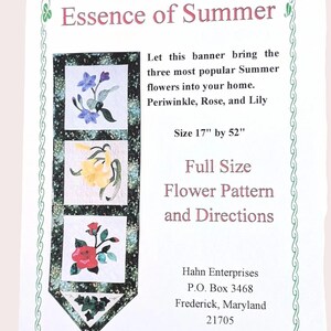 May include: A banner titled "Essence of Summer" featuring floral patterns of periwinkle, rose, and lily. The banner is 17 inches by 52 inches and includes full-size flower patterns and directions.