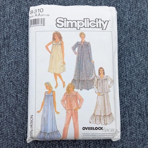 May include: Simplicity sewing pattern packet featuring illustrations of sleepwear designs. The packet includes a variety of styles, including nightgowns, robes, and pajama sets. The packet has the number 8310 and the size AA (PT-LG).