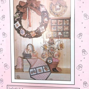 May include: A display of Easter-themed decorations, including wreaths, hanging ornaments, and a decorative basket. The color palette includes soft pinks, browns, and whites, creating a rustic and festive atmosphere. The decorations feature Easter eggs and other spring motifs.
