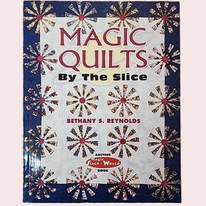 May include: A book titled "MAGIC QUILTS By The Slice" with a blue border and a white background. The cover features a repeating pattern of stylized floral designs in red, gold, and white. The author's name, Bethany S. Reynolds, is also visible.