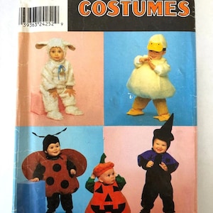 May include: Simplicity Costumes pattern featuring four baby costumes: a lamb, a duck, a ladybug, and a witch. The costumes are displayed on a pink and blue background. The pattern is for sizes A 1/2, 1, 2, 3, 4.