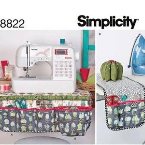 May include: A sewing pattern by Simplicity, featuring a sewing machine, a cactus-themed organizer, and a table runner. The organizer has multiple pockets and a cactus print. The pattern number is 8822.