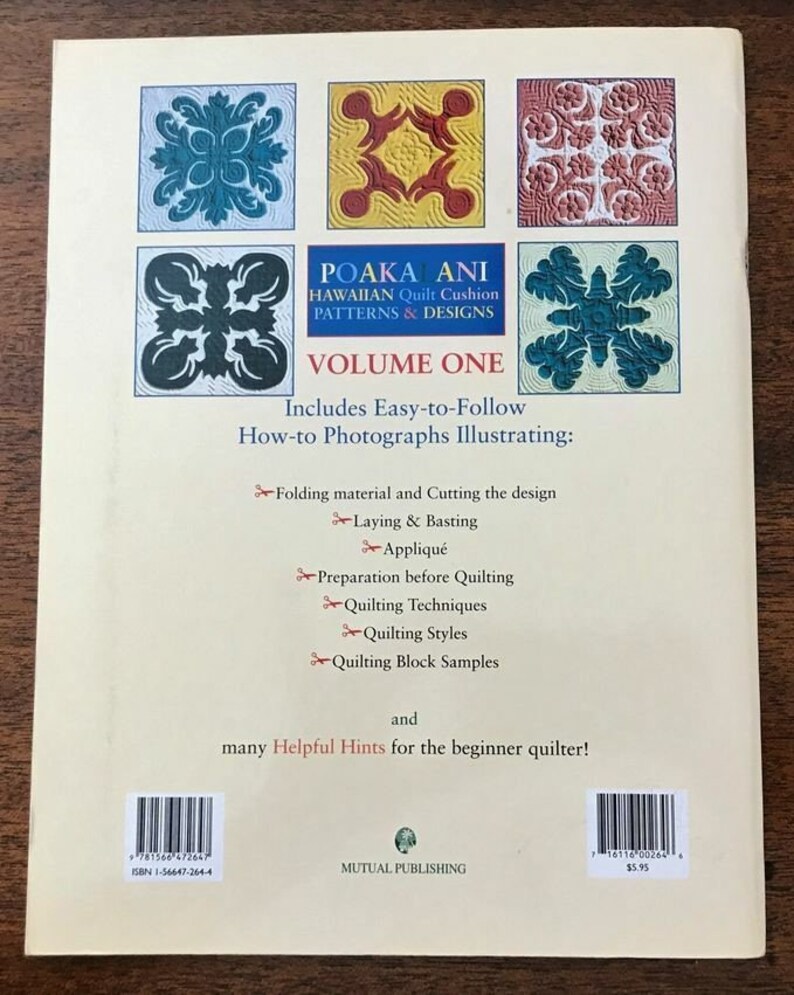 May include: The back cover of a book titled "POAKA ANI Hawaiian Quilt Cushion Patterns & Designs Volume One." It features colorful quilt block designs and includes instructions for quilting techniques. The book is published by Mutual Publishing.