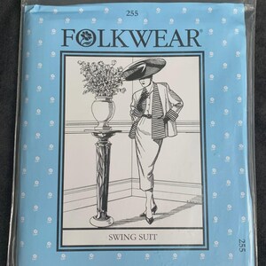 May include: A light blue sewing pattern envelope labeled FOLKWEAR 255 SWING SUIT. The front features a black and white illustration of a person wearing a jacket and skirt, standing next to a pedestal with a vase of flowers, all in a plastic bag.