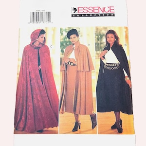 May include: An Essence Collection sewing pattern envelope featuring three cape designs. Design C is a long red hooded cape. Design A is a tan cape with a collar. Design B is a black cape. The envelope includes a barcode and the text FAST&EASY.