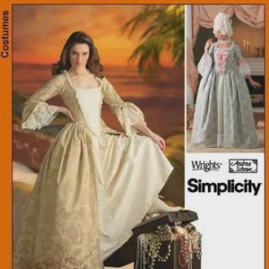 May include: A woman in a cream-colored historical costume dress with a square neckline and long sleeves with lace cuffs. The dress has a patterned bodice and a full skirt. The image also shows a Simplicity pattern.