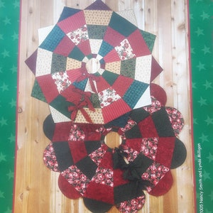 May include: A patchwork Christmas tree skirt with a floral and geometric design. The tree skirt is made of red, black, and cream-colored fabric. The text "Home for Christmas" and "Patchwork Tree Skirt" are visible.