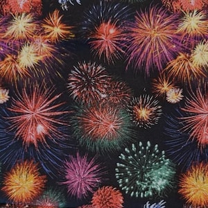 May include: A fabric with a repeating pattern of colorful fireworks bursting against a black background. The fireworks display a variety of colors, including red, orange, yellow, purple, and green, creating a festive and celebratory design.