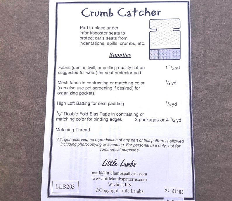 May include: A sewing pattern instruction sheet titled Crumb Catcher for an infant or booster seat protector pad. It lists required supplies including fabric, mesh, batting, and bias tape with specific yardage measurements in inches and yards.