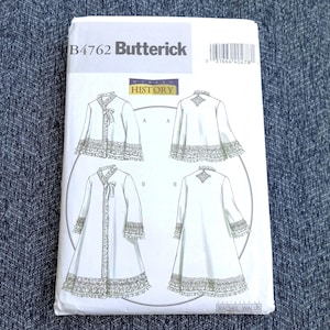 May include: A Butterick B4762 sewing pattern envelope featuring Making History designs. The white paper packet displays line drawings of two robe styles with ruffled trim, lace details, and ribbon closures, along with a barcode and text.