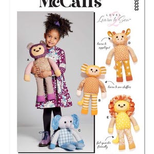 May include: McCall's M8333 sewing pattern featuring stuffed animal designs. The pattern includes instructions for making a bear, giraffe, monkey, elephant, and lion. The image shows a young girl holding a bear stuffed animal.