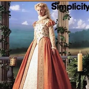 May include: A Simplicity sewing pattern for a historical-style gown featuring a cream-colored bodice with a floral pattern, long sleeves with puffed shoulders, a high collar, and a full-length, rust-orange skirt with a decorative gold-toned trim.