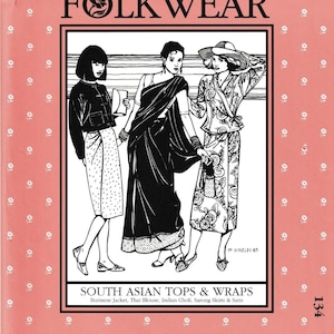 May include: A vintage sewing pattern cover featuring three illustrated figures in South Asian attire. The cover is pink with white floral accents and the text "FOLKWEAR" and "SOUTH ASIAN TOPS & WRAPS". The pattern includes Burmese jackets, Thai blouses, and saris.