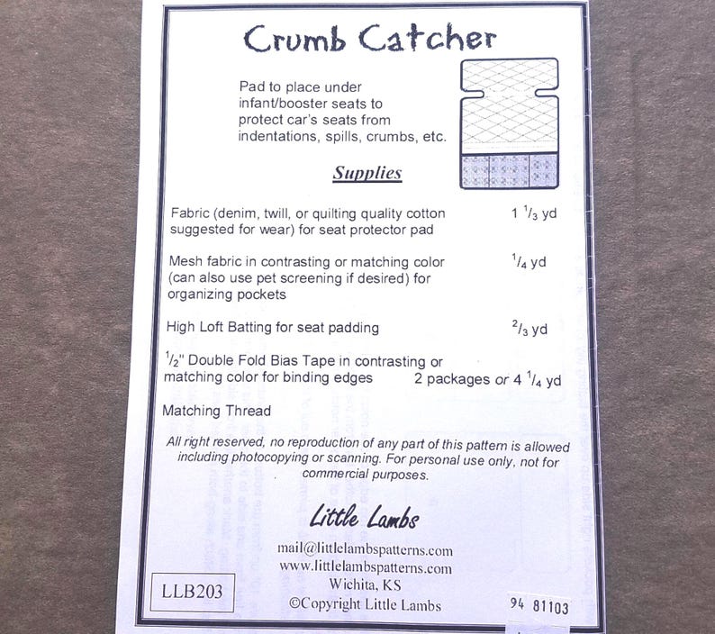 May include: A sewing pattern sheet titled Crumb Catcher for an infant or booster seat protector pad. It lists required supplies including fabric, mesh, batting, and bias tape with measurements in yards. Includes contact info for Little Lambs.