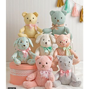 May include: A collection of handmade stuffed animal patterns, including bears, a dog, and a cat. The plush toys are in various colors, such as yellow, blue, pink, and gray, and are adorned with bows. The Simplicity logo is at the top.