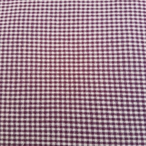 May include: Close-up of a fabric with a small, checkered pattern. The pattern features a repeating grid of dark purple and off-white squares, creating a classic gingham design. The fabric appears to be tightly woven.
