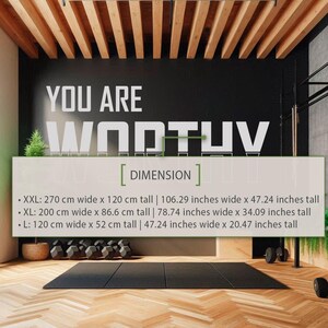 May include: A black wall with white text that reads "YOU ARE WORTH IT" and a list of dimensions in centimeters and inches for different sizes of a product. The text "DIMENSION" is in brackets below the text "YOU ARE WORTH IT".