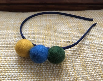 Felted wool pom pom headband in gold, green, and blue