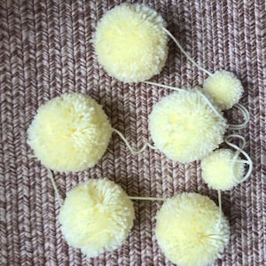 Light yellow yarn pom pom garland