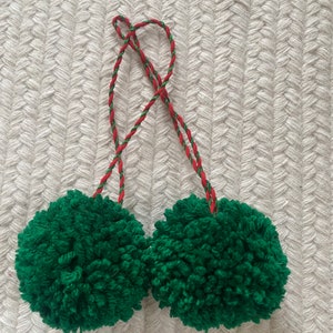 Two yarn pom tree ornaments on coordinating cord. Green or red