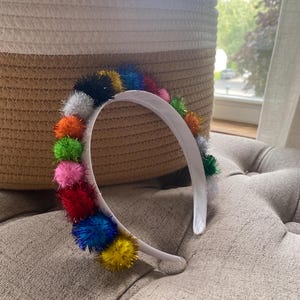 bright and colorful tinsel pom pom headband