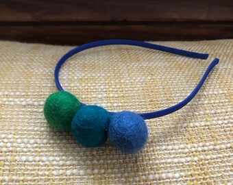 Felted wool pom pom headband in green, teal, and blue