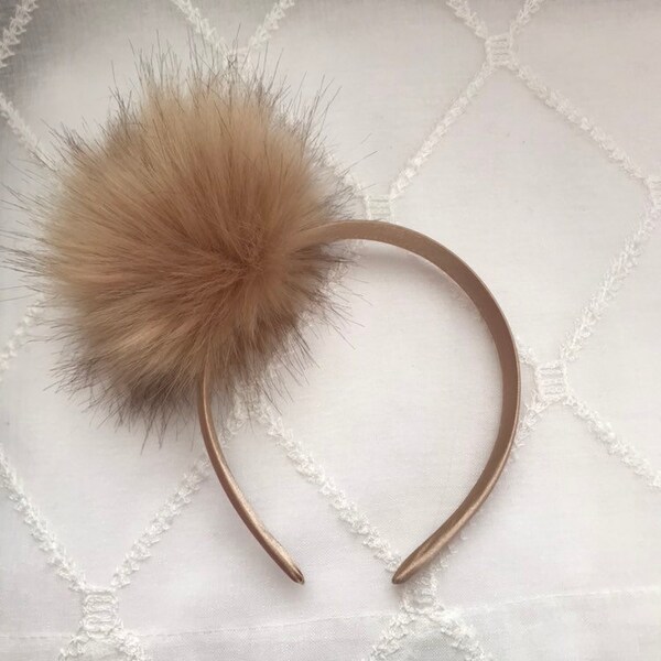 Brown faux pom pom headband on coordinating satin covered band