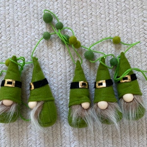Five green gnomes on a pom pom garland
