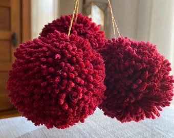 Three burgundy garnet red yarn pom pom ornaments