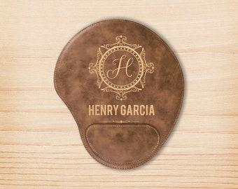 May include: Brown leather mouse pad with a decorative monogram and the name "HENRY GARCIA" engraved in gold.
