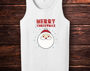 May include: White tank top with a Santa Claus graphic. The Santa face is round with a white beard, red hat, and rosy cheeks. The words "MERRY CHRISTMAS" are printed in red above the Santa face, with small green dots scattered around the design.