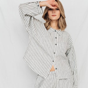 May include: A white and gray striped linen pajama set with a collared shirt and shorts.