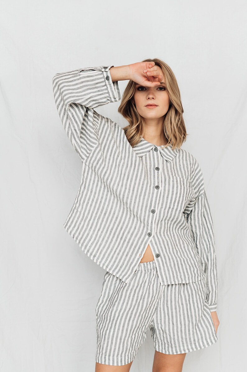 May include: A white and gray striped linen pajama set with a collared shirt and shorts.