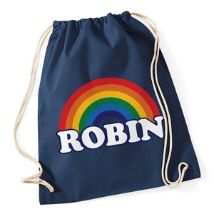 May include: A navy blue drawstring bag with a rainbow and the name "ROBIN" in white letters.