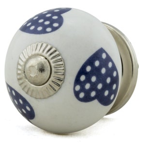 May include: White ceramic knob with three blue polka dot hearts. The knob has a silver metal base.