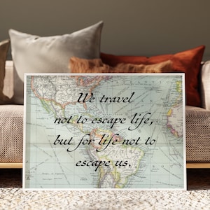 May include: A framed print featuring a vintage world map with the quote, "We travel not to escape life, but for life not to escape us." The print is displayed on a sofa with pillows in shades of brown and beige.