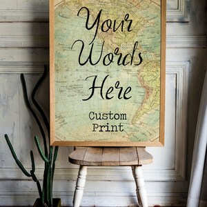 May include: A framed print with a vintage world map background. The text "Your Words Here" is written in cursive script. Below the text is the phrase "Custom Print".