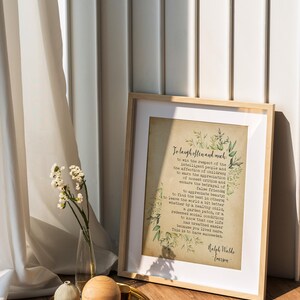 May include: A framed print with a quote by Ralph Waldo Emerson on a vintage-style background with green foliage. The quote reads "To laugh often and much... This is to have succeeded."