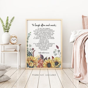 Puede incluir: Una cita de arte de pared imprimible con un fondo blanco y un dise&ntilde;o floral con girasoles, hojas y bayas. La cita dice "Re&iacute;r a menudo y mucho; ganar el respeto de la gente inteligente y el afecto de los ni&ntilde;os; ganarse la apreciaci&oacute;n de los cr&iacute;ticos honestos y soportar la traici&oacute;n de los falsos amigos; encontrar la belleza en los dem&aacute;s; dejar el mundo un poco mejor, ya sea por un ni&ntilde;o sano, un huerto o una condici&oacute;n social redimida; saber que una vida ha respirado m&aacute;s f&aacute;cilmente porque viviste aqu&iacute;. Esto es tener &eacute;xito. - Ralph Waldo Emerson". El texto "Marco no incluido" est&aacute; en la parte inferior de la imagen.