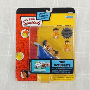 May include: The Simpsons The Octuplets figure set includes a blue stroller with five baby figures. The packaging features a yellow background with the Simpsons logo and the words "The Octuplets".