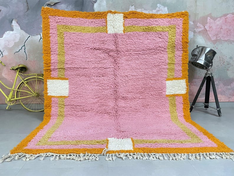 Custom handmade Moroccan wool rug in soft pink, gold, and orange.