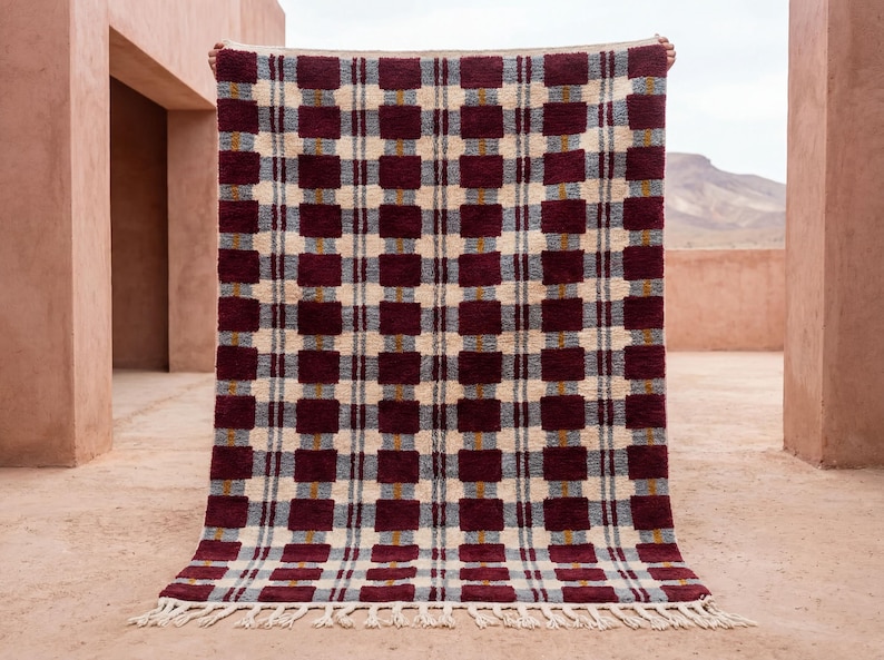 Burgundy Moroccan Rug handwoven in Morocco from 100% natural wool, featuring a bold checkerboard pattern in deep burgundy, ivory, soft grey, and subtle mustard accents. This contemporary Berber area rug has a plush textured pile and clean geometric design, ideal for modern, Scandinavian, and boho interiors. Artisan-made, warm, durable, and perfect as a living room or bedroom statement rug.